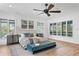 Spacious main bedroom with natural light, wood floors and a teal velvet bench at 4407 W Dale Ave, Tampa, FL 33609