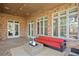 Covered outdoor patio boasts brick walls, neutral furniture, and multiple windows offering natural light at 4407 W Dale Ave, Tampa, FL 33609