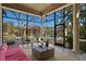 Serene screened-in patio providing relaxing views of the pool, lush landscaping, and backyard oasis at 4407 W Dale Ave, Tampa, FL 33609