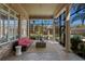 Inviting screened-in patio with brick accents offering views of the pool and landscaped backyard at 4407 W Dale Ave, Tampa, FL 33609
