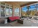 Screened-in patio featuring brick walls, neutral furniture, and scenic views of lush greenery at 4407 W Dale Ave, Tampa, FL 33609