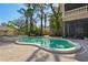 Sparkling pool features lush landscaping, a spa, and a screened-in patio for year-round outdoor enjoyment at 4407 W Dale Ave, Tampa, FL 33609