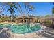 Inviting pool area showcasing a pristine pool, spa, and charming brick pool house for ultimate relaxation at 4407 W Dale Ave, Tampa, FL 33609
