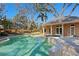 Tranquil pool surrounded by mature trees, with a spa and well-appointed pool house for outdoor enjoyment at 4407 W Dale Ave, Tampa, FL 33609