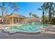 Beautiful pool area featuring lush landscaping, brick building, and a separate spa for outdoor enjoyment at 4407 W Dale Ave, Tampa, FL 33609
