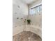Walk-in shower featuring stylish tiling, built-in seating, and multiple shower heads at 4407 W Dale Ave, Tampa, FL 33609
