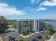 Waterfront condo building with parking and lush tropical landscaping at 4823 Ebbtide Ln # 403, Port Richey, FL 34668