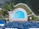 Community pool and surrounding waterfront property at 4823 Ebbtide Ln # 403, Port Richey, FL 34668