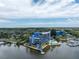 Aerial view of waterfront condo building with pool and private boat dock at 4823 Ebbtide Ln # 403, Port Richey, FL 34668