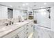 Elegant bathroom with double vanity, marble flooring, and a walk-in shower at 4823 Ebbtide Ln # 403, Port Richey, FL 34668