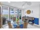 Small dining area with glass table, wicker chairs and balcony access at 4823 Ebbtide Ln # 403, Port Richey, FL 34668