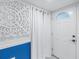 Bright condo entry with white door and blue accent wall at 4823 Ebbtide Ln # 403, Port Richey, FL 34668