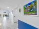 Condo hallway with marble floor and artwork at 4823 Ebbtide Ln # 403, Port Richey, FL 34668