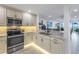 Updated kitchen with white cabinets, marble countertops and under-cabinet lighting at 4823 Ebbtide Ln # 403, Port Richey, FL 34668