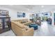 Spacious living room featuring a large sectional sofa and a teal ottoman at 4823 Ebbtide Ln # 403, Port Richey, FL 34668