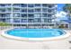 Relaxing community pool with a tranquil, curved design at 4823 Ebbtide Ln # 403, Port Richey, FL 34668