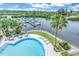 Inviting community pool with waterfront views and lounge chairs at 4823 Ebbtide Ln # 403, Port Richey, FL 34668
