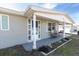 House exterior featuring a covered porch with white columns and seating at 4913 Lemonwood Loop, Holiday, FL 34690