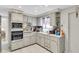 Galley style kitchen with stainless steel appliances and light gray cabinets at 4913 Lemonwood Loop, Holiday, FL 34690