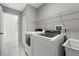 Clean laundry room features washer, dryer, and extra space at 5141 Courtland Rd, Spring Hill, FL 34608