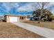 House exterior showcasing a white garage door and arched entryway at 6025 Beechwood Dr, New Port Richey, FL 34653