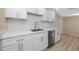 Modern white kitchen with stainless steel appliances and quartz countertops at 6025 Beechwood Dr, New Port Richey, FL 34653