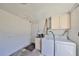 Convenient laundry room with washer, dryer, and overhead cabinets at 6025 Florida S Cir, Apollo Beach, FL 33572