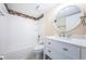 Clean bathroom with white vanity, bathtub, and large mirror at 6145 Sun Blvd # 103, St Petersburg, FL 33715