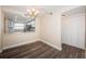 Dining area with kitchen view and wood-look floors at 6145 Sun Blvd # 103, St Petersburg, FL 33715