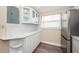 White kitchen with ample storage and quartz countertops at 6145 Sun Blvd # 103, St Petersburg, FL 33715