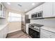 Updated kitchen featuring white cabinets and quartz counters at 6145 Sun Blvd # 103, St Petersburg, FL 33715