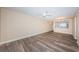 Spacious living room featuring wood-look floors and ceiling fan at 6145 Sun Blvd # 103, St Petersburg, FL 33715