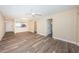 Open living room with kitchen view and wood-look floors at 6145 Sun Blvd # 103, St Petersburg, FL 33715