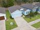 This lovely home features a two-car garage and a well-manicured lawn at 711 Old Windsor Way, Spring Hill, FL 34609