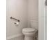 Small bathroom with toilet and grab bars for accessibility at 711 Old Windsor Way, Spring Hill, FL 34609