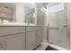 Main bathroom with double vanity and walk-in shower at 711 Old Windsor Way, Spring Hill, FL 34609