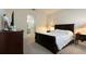 Bright bedroom with a dark brown sleigh bed and en-suite bathroom at 711 Old Windsor Way, Spring Hill, FL 34609
