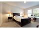 Well lit bedroom with a dark brown sleigh bed and window seating at 711 Old Windsor Way, Spring Hill, FL 34609