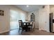 Cozy dining area with a table for four and access to a patio at 711 Old Windsor Way, Spring Hill, FL 34609