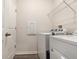 Laundry room with washer, dryer, and overhead shelving at 711 Old Windsor Way, Spring Hill, FL 34609