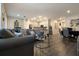 Spacious living room with hardwood floors and a view into the kitchen at 711 Old Windsor Way, Spring Hill, FL 34609