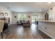 Open floor plan living area with wood-look flooring at 711 Old Windsor Way, Spring Hill, FL 34609