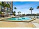 Inviting community pool with ample lounge chairs at 7425 Bay Island S Dr # 104, South Pasadena, FL 33707