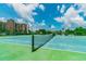 Community tennis court with net, ready for play at 7425 Bay Island S Dr # 104, South Pasadena, FL 33707