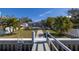 Landscaped backyard with brick pathway leading to waterfront at 743 Chesapeake Dr, Tarpon Springs, FL 34689