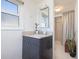Small bathroom with single vanity, shower, and window at 743 Chesapeake Dr, Tarpon Springs, FL 34689