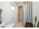 Small bathroom with shower and window at 743 Chesapeake Dr, Tarpon Springs, FL 34689