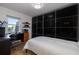 Bedroom with a built-in desk, black sliding doors, and window at 743 Chesapeake Dr, Tarpon Springs, FL 34689