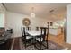 Bright dining room with marble table and modern chandelier at 743 Chesapeake Dr, Tarpon Springs, FL 34689