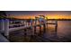 Private dock with boat lift, illuminated at sunset at 743 Chesapeake Dr, Tarpon Springs, FL 34689